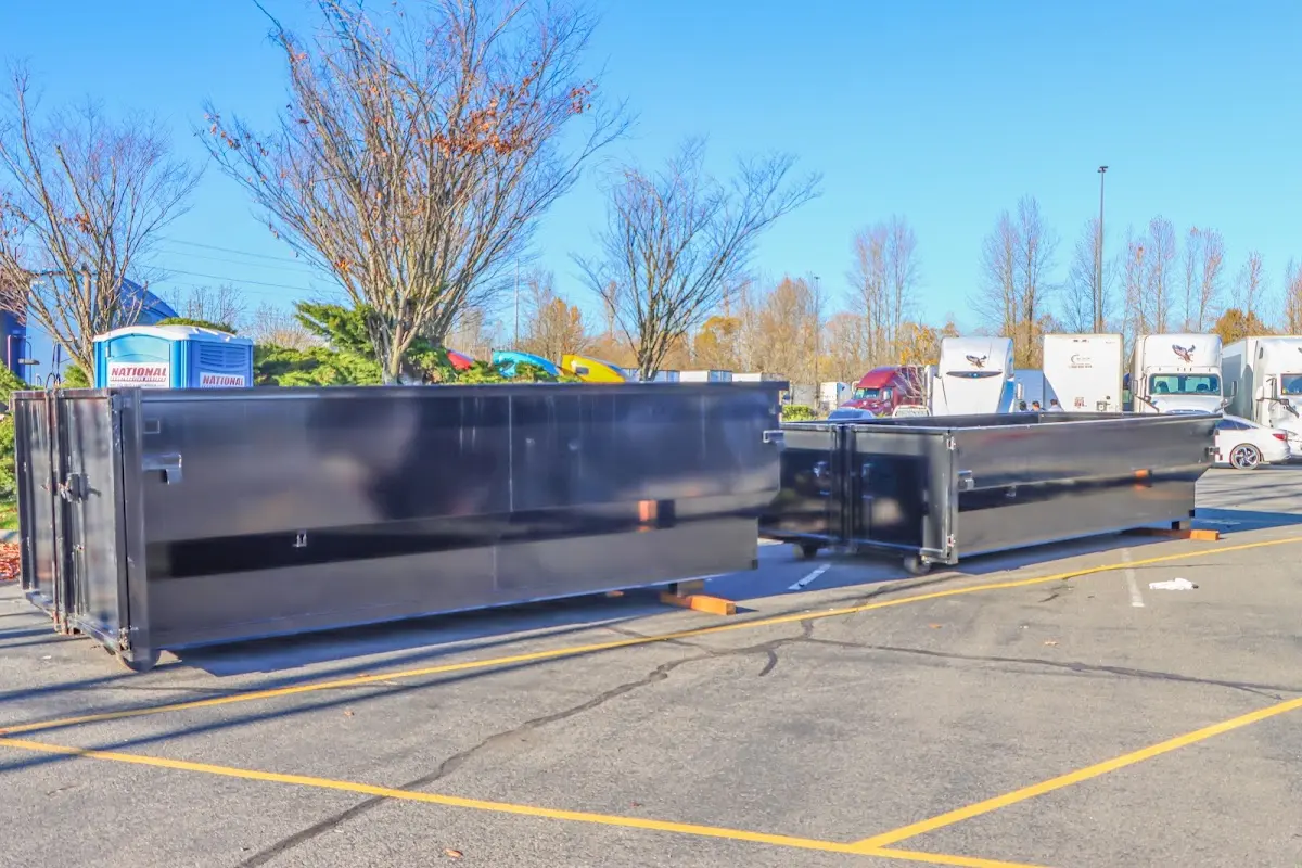 Professional dumpster rental service with roll-off container on residential driveway in Argyle